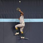 Watch: A’s outfielder scales wall to rob a home run